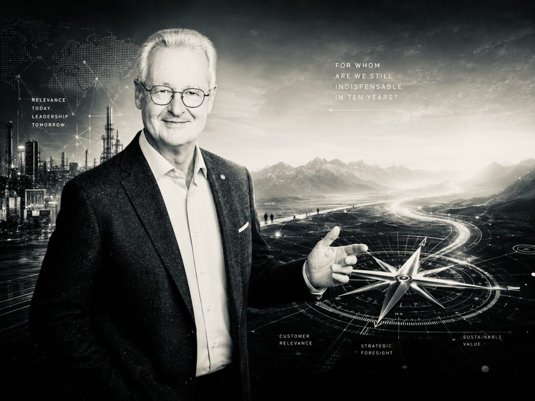 Portrait of a smiling man in a suit before a futuristic landscape with a compass, symbolizing leadership and foresight in business.