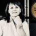 Black-and-white portrait of a smiling woman with her hand on her chin, next to a gold circular badge reading ‘Best Value Interim Manager 2026/27’.