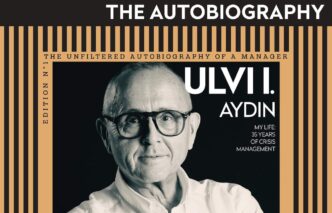 Book cover for Ulvi Aydın's autobiography, portrait of the author wearing glasses with an orange striped frame and bold title.