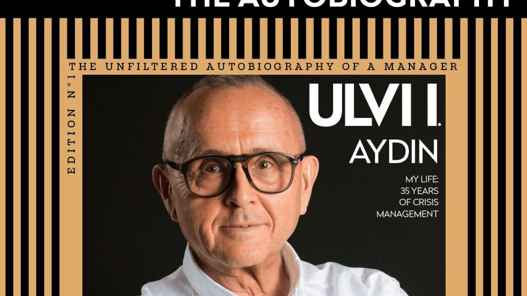 Book cover showing a man with glasses; title 'The Autobiography' with a black and gold striped frame