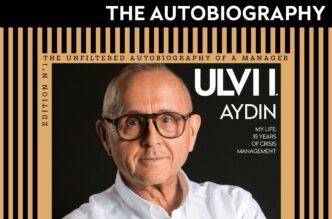 Book cover showing a man with glasses; title 'The Autobiography' with a black and gold striped frame