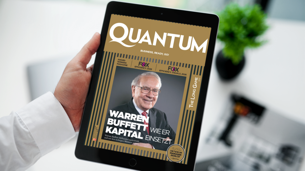 Tablet screen showing a magazine cover titled QUANTUM with a smiling older man in a suit on the cover