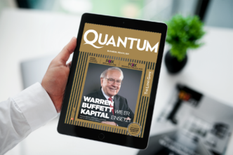 Tablet screen showing a magazine cover titled QUANTUM with a smiling older man in a suit on the cover