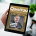 Tablet screen showing a magazine cover titled QUANTUM with a smiling older man in a suit on the cover