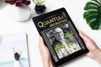 Tablet held by hands showing a magazine cover titled 'Quantum Recruiting' on screen with a photo of a man and recruitment headlines (Dan Shapiro)